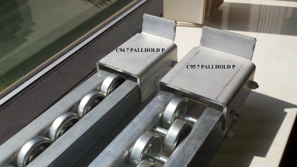 Metal skate wheel pallet flow lanes have metal stops for single wheel pallet flow and staggered wheel pallet flow