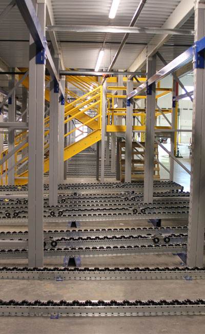 Pallet Flow Rack Pick Modules deliver pallets to concentrated work cells within a multi-level system that flow forward to worker positions for product breakdown.